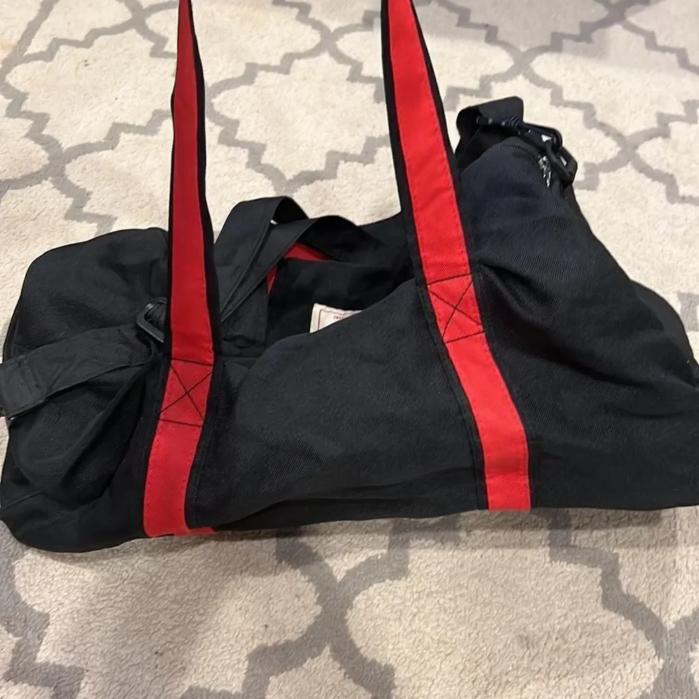 True Religion Black and Red Strap Duffel Bag
